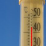 Thermometer vor blauem Hintergrund zeigt fast 40 Grad Außentemperatur