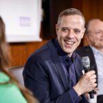 Bundes-CIO Markus Richter mit Mikro in der Hand auf einem Podium.